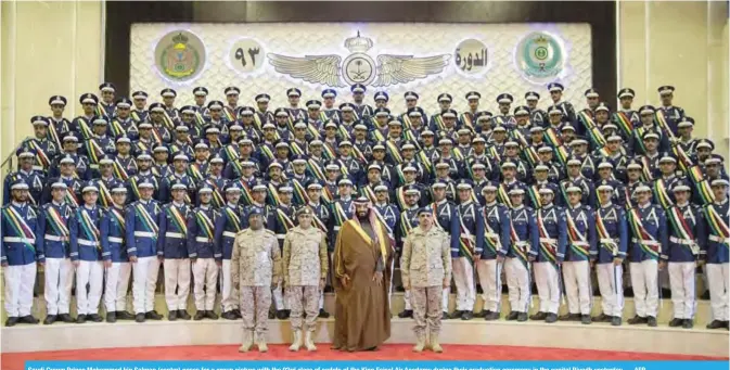  ?? — AFP ?? Saudi Crown Prince Mohammed bin Salman (center) poses for a group picture with the 93rd class of cadets of the King Faisal Air Academy during their graduation ceremony in the capital Riyadh yesterday.