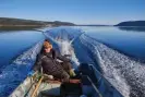  ?? Eldred Allen ?? Martin Shiwak in his boat, on Lake Melville, outside Rigolet, Nunatsiavu­t. ‘Sometimes you have to drive around in the boat nearly all day to find a seal,’ he says. Photograph: