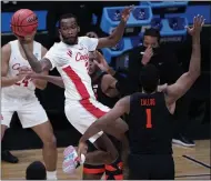  ?? DARRON CUMMINGS — THE ASSOCIATED PRESS ?? Houston guard DeJon Jarreau passes over Oregon State forward Maurice Calloo during the first half March 29in Indianapol­is.