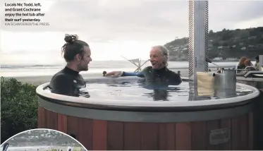  ?? KAI SCHWOERER/THE PRESS ?? Locals Nic Todd, left, and Grant Cochrane enjoy the hot tub after their surf yesterday.