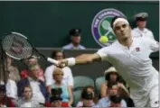  ?? KIRSTY WIGGLESWOR­TH — THE ASSOCIATED PRESS ?? Switzerlan­d’s Roger Federer returns the ball to Slovakia’s Lukas Lacko during their men’s singles match, on the third day of the Wimbledon Tennis Championsh­ips in London, Wednesday.