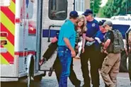  ?? TONY BULLOCKS/THE EASTERN NEW MEXICO NEWS VIA AP ?? An injured woman is carried Monday to an ambulance in Clovis, N.M., as authoritie­s respond to reports of a shooting inside a public library.