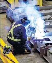  ??  ?? A shipyard welder working on the second offshore fisheries science vessel in the panel line shop.