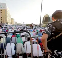  ?? AFP ?? UNDER THE WATCHFUL EYE ... Faithful pray outside the Mohammad Al Amin mosque in downtown Beirut. —