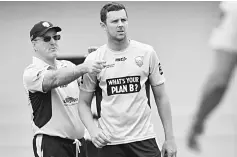  ??  ?? Josh Hazlewood (right) speaks with coach Geoff Lawson during training with the New South Wales state cricket team in Sydney. — AFP photo