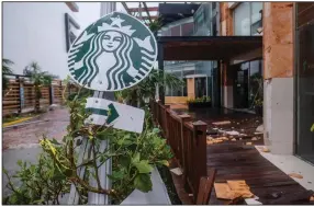  ??  ?? A Starbucks coffee shop sign was knocked over by winds from Hurricane Delta in Cancun, Mexico, in this file photo. The global coffee shop chain said Thursday that it plans to increase racial diversity in its workforce.
(AP/Victor Ruiz Garcia)