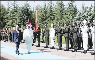  ?? (AFP) ?? Turkish Prime Minister Binali Yildirim (left), and Prime Minister of Kuwait, Sheikh Jaber Al-Mubarak Al-Hamad AlSabah walk past the honor guard during a welcome ceremony ahead of their meeting at Cankaya Palace in Ankara
on Sept 14.