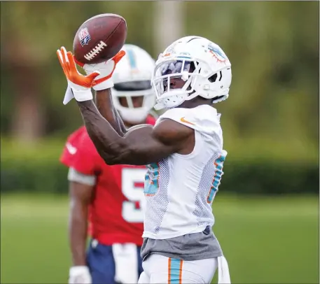  ?? AP ?? FAST AND FURIOUS: Dolphins wide receiver Tyreek Hill catches a pass during practice at Hard Rock Stadium on Monday.