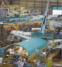  ?? Francine Orr Los Angeles Times ?? THE DEALS have created “nervous excitement” among suppliers, an executive said. Above, Boeing’s Everett, Wash., plant.