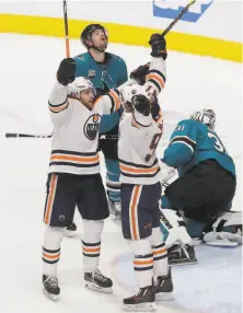  ?? Jeff Chiu / Associated Press ?? The Oilers’ Leon Draisaitl (bottom left) celebrates with Connor McDavid after scoring in overtime at SAP Center.