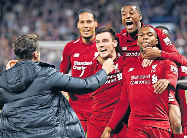  ??  ?? Fan-tastic: A Liverpool supporter rushes to celebrate with Daniel Sturridge, far right, and team-mates after the striker’s stunning equalising goal against Chelsea