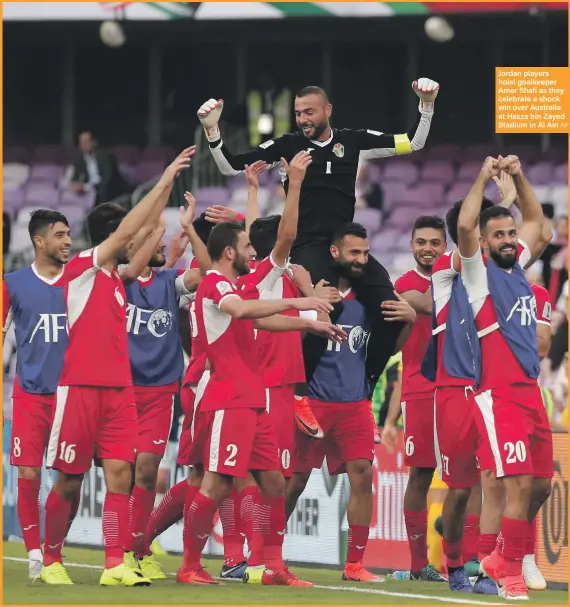  ?? AP ?? Jordan players hoist goalkeeper Amer Shafi as they celebrate a shock win over Australia at Hazza bin Zayed Stadium in Al Ain