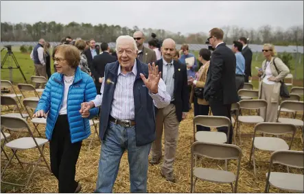  ?? DAVID GOLDMAN — THE ASSOCIATED PRESS FILE ?? Former President Jimmy Carter, right, and his wife Rosalynn leave a ribbon cutting ceremony for a solar panel project on farmland he owns in their hometown of Plains, Ga., on Feb. 8, 2017.