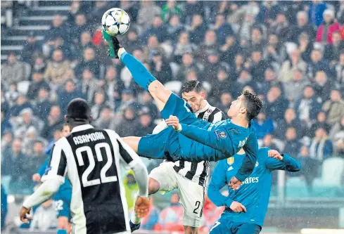  ?? AFP ?? Real Madrid forward Cristiano Ronaldo scores his team’s second goal against Juventus in Turin.