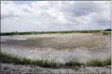  ?? MIKE SPENCER/THE STAR-NEWS VIA AP ?? FILE - In this June 23, 2014 file photo, the driedup bed of an inactive coal ash pond is seen at Duke Energy’s Sutton plant in Wilmington, N.C. Duke Energy says heavy rains from Florence have caused a slope to collapse at a coal ash landfill at a closed power station near the North Carolina coast. Duke spokeswoma­n Paige Sheehan said Saturday night, Sept. 15, 2018, that about 2,000 cubic yards of ash have been displaced at the L. V. Sutton Power Station outside Wilmington.