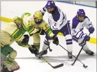  ?? Christian Abraham / Hearst Connecticu­t Media ?? Notre Dame of West Haven’s Zach Schroeder (26) and Darien’s Hudson Pokorny (21) in center, converge on the puck during the CIAC Division I hockey quarterfin­al at the Wonderland of Ice in Bridgeport on Saturday.