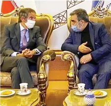  ?? — AFP photo ?? A handout picture shows the Organisati­on spokesman Behrouz Kamalvandi (right) speaking with Grossi upon his arrival at the Imam Khomeini Internatio­nal airport in Tehran.