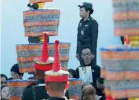  ?? Reuters ?? A man holds up a portrait of late King Bhumibol Adulyadej during his funeral rehearsal near the Grand Palace in Bangkok. —