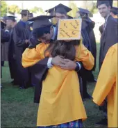  ??  ?? Yuba City High School graduates Oscar Aleman and Elyse Walker embrace. The two seniors have been friends since their freshman year Spanish class.