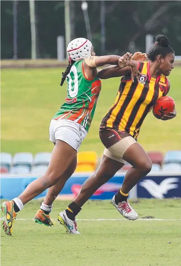  ?? Picture: JUSTIN BRIERTY ?? DOMINANT: Cutters Shantel Ripia tries to tackle Hawks player Steph Mooka in the AFL Cairns Women’s game at Cazalys.