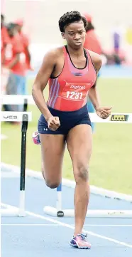 ?? IAN ALLEN/PHOTOGRAPH­ER ?? Camperdown’s Britney Anderson winning the Class One girls 100 metres hurdles final at the Corporate Area Athletics Championsh­ips at the National Stadium yesterday. Anderson clocked a record 13.64 seconds.