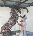  ??  ?? FINISHING TOUCH: Jennie Scott’s scrap metal sculpture honours the humble horse.