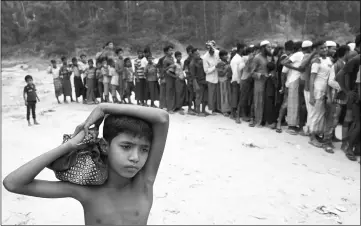  ??  ?? Rohingya refugees line up to receive blankets outside Kutupalong refugee settlement near Cox’s Bazar, Bangladesh. — Reuters photo