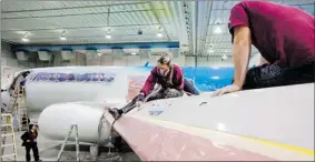  ?? DARIO AYALA/ THE GAZETTE ?? Workers sand the wings of an airplane at the overhaulin­g centre of Premier Aviation in TroisRivie­res. Premier is advertisin­g heavily for maintenanc­e workers.