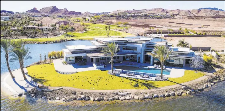  ?? Synergy/Sotheby’s Internatio­nal Realty ?? An 8,838-square-foot home at 23 Summer House Drive in Henderson’s Lake Las Vegas community recently sold for $6.5 million.