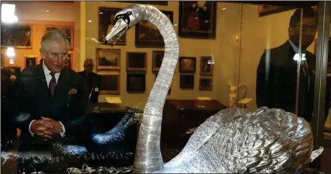  ??  ?? The Prince of Wales admires at the Silver Swan musical automaton, which dates from 1773, during a visit to the Bowes Museum in Barnard Castle