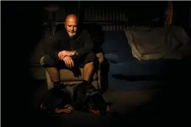  ?? Photograph: Rachel Mounsey/The Guardian ?? Doug Reidy and his therapy dog, Max, at his Murrindal property in Victoria’s east Gippsland.