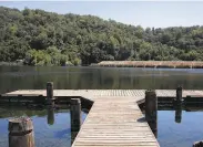  ?? Jessica Christian / The Chronicle ?? A dock extends into Boronda Lake at Foothills Park, which has been limited to Palo Alto residents.