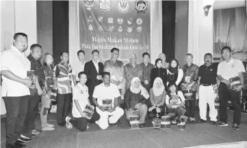  ??  ?? Manyin (standing, eighth left) – flanked by Abdul Karim on his right and Lee – joins Ting (standing, sixth left), Kameri (standing, fifth left), Normala (standing, 10th left) as well as team managers and other guests for a group photo on stage.