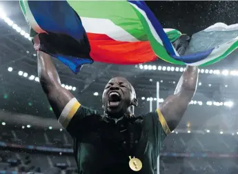  ?? ?? Springbok Bongi Mbonambi celebrates with the South African flag after the team’s victory at the Rugby World Cup last year. Photo: Gaspafotos/mb Media/getty Images