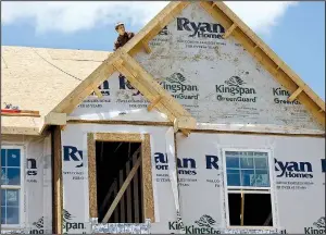  ?? AP/KEITH SRAKOCIC ?? Builders work on the roof of a house under constructi­on in Butler County, Pa., in June. The National Associatio­n of Home Builders/Wells Fargo said its homebuilde­r sentiment index released Monday fell for September compared with August.