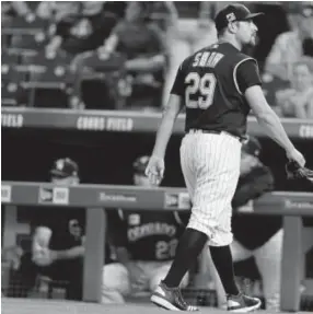  ?? Associated Press file ?? Rockies relief pitcher Bryan Shaw heads to the dugout after giving up six runs to the Diamondbac­ks in the eighth inning Saturday.