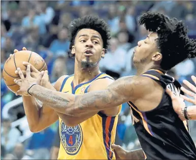  ?? CHRIS CARLSON — THE ASSOCIATED PRESS ?? Warriors guard Quinn Cook, left, scored a career-high 28points Saturday to set an NBA record for two-way contract players.