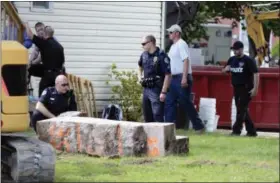  ?? THE DAILY ITEM VIA THE ASSOCIATED PRESS ?? In this 2017 photo, police officers look over a slab of concrete pulled out of the basement of a home in Milton, Pa. Investigat­ors hope cement taken from the Pennsylvan­ia basement will solve the 1989 disappeara­nce of Barbara Elizabeth Miller by...