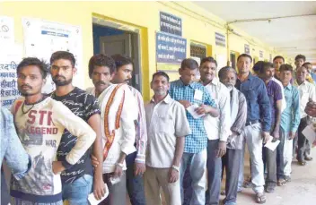  ??  ?? Voters wait for their turn to vote at a polling booth in Raipur on Tuesday.