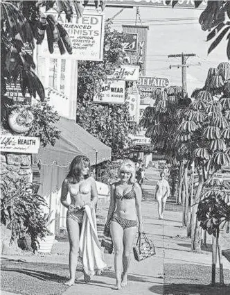  ?? Pictures: Facebook ?? GLAMOUR STRIP: Little wonder the Gold Coast was such an iconic holiday destinatio­n. This Cavill Ave photo, courtesy of Brett Carroll, captures its easy-going glamorous lifestyle in the mid-1960s, with famous bikini designer Paula Stafford's shop behind.