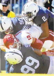  ?? JUSTIN K. ALLER / GETTY ?? Penn State’s Austin Johnson (99, Marcus Allen (2) and Garrett Sickels sack Indiana’s Zander Diamont Saturday at Beaver Stadium./