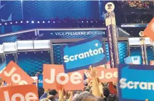  ?? LAURAOLSON/THE MORNING CALL ?? Democrats wave signs for former Vice President Joe Biden as he takes the stage at the Democratic National Convention.
