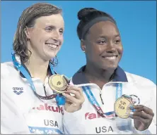  ?? MICHAEL SOHN — THE ASSOCIATED PRESS ?? Katie Ledecky, and Simone Manuel, from left, were happy after striking gold at the World Aquatics meet in Hungary. They looked dominant Friday in the 200-meter freestyle preliminar­y at the TYR Pro Series in Santa Clara.