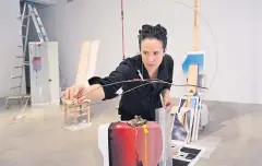  ??  ?? Sarah Sze adjusts her artwork.