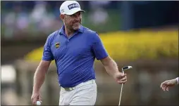  ?? GERALD HERBERT — THE ASSOCIATED PRESS ?? Lee Westwood smiles after making a birdie putt on the 16th hole during the third round of The Players Championsh­ip on Saturday.