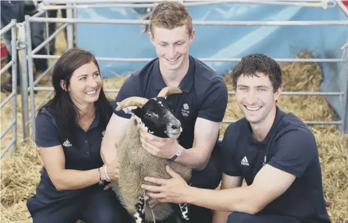  ??  ?? 0 No black sheep in the Muirhead family as GB curlers, from left, Eve, Thomas and Glen visit the Royal Highland Show yesterday.