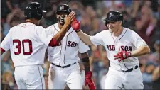  ?? CHARLES KRUPA/AP PHOTO ?? Brock Holt, right, celebrates with Tzu-Wei Lin (30) and Eduardo Nunez after his after his pinch-hit, three-run home run rallied the Red Sox to a 7-2 win over a Toronto on Tuesday night and becoming the first team to clinch a postseason playoff berth.