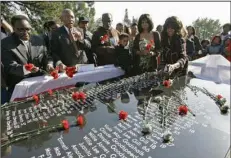  ?? (AP/Eric Risberg) ?? On the 30th anniversar­y of the mass suicide and homicide in Jonestown, Guyana, people gathered in Oakland, Calif., to dedicate a memorial in their memory. More than 900 people perished on Nov. 18, 1978, including dozens of Arkansas natives.