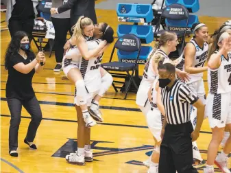  ?? Michael Thomas / Associated Press ?? Missouri State forward Jasmine Franklin hugs teammate Paige Rocca (left) after the Lady Bears’ win over Wright State. Franklin had a doubledoub­le with 11 points and 11 rebounds.