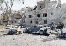  ?? THE ASSOCIATED PRESS ?? Several cars along the road to the airport in southeast Damascus, Syria, were damaged Sunday.